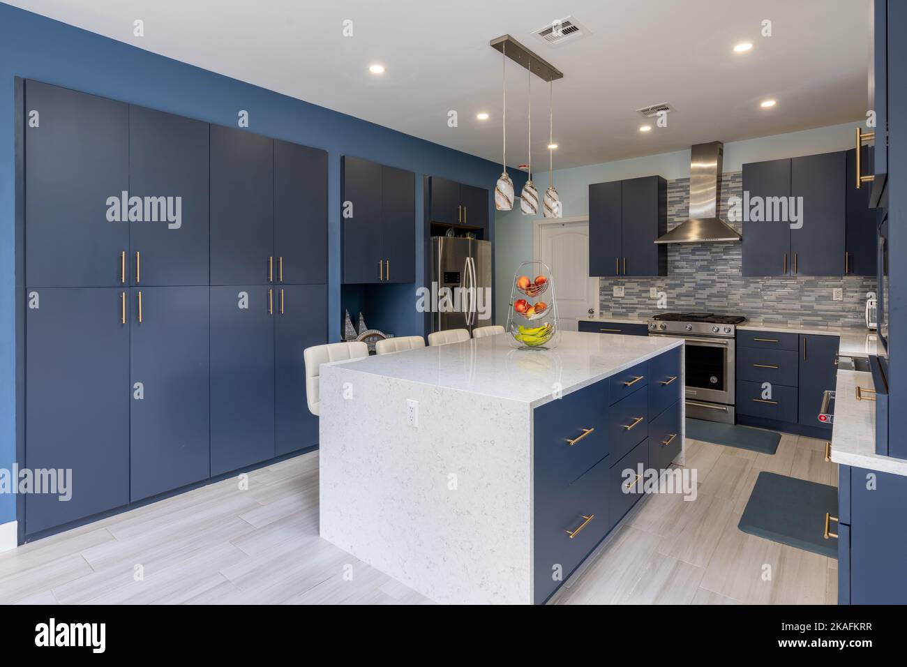 The interior of new modern open kitchen with blue and white furniture ...