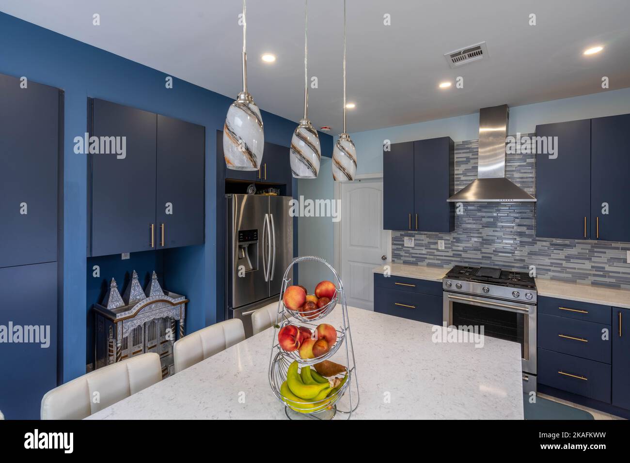 The interior of new modern open kitchen with blue and white furniture ...