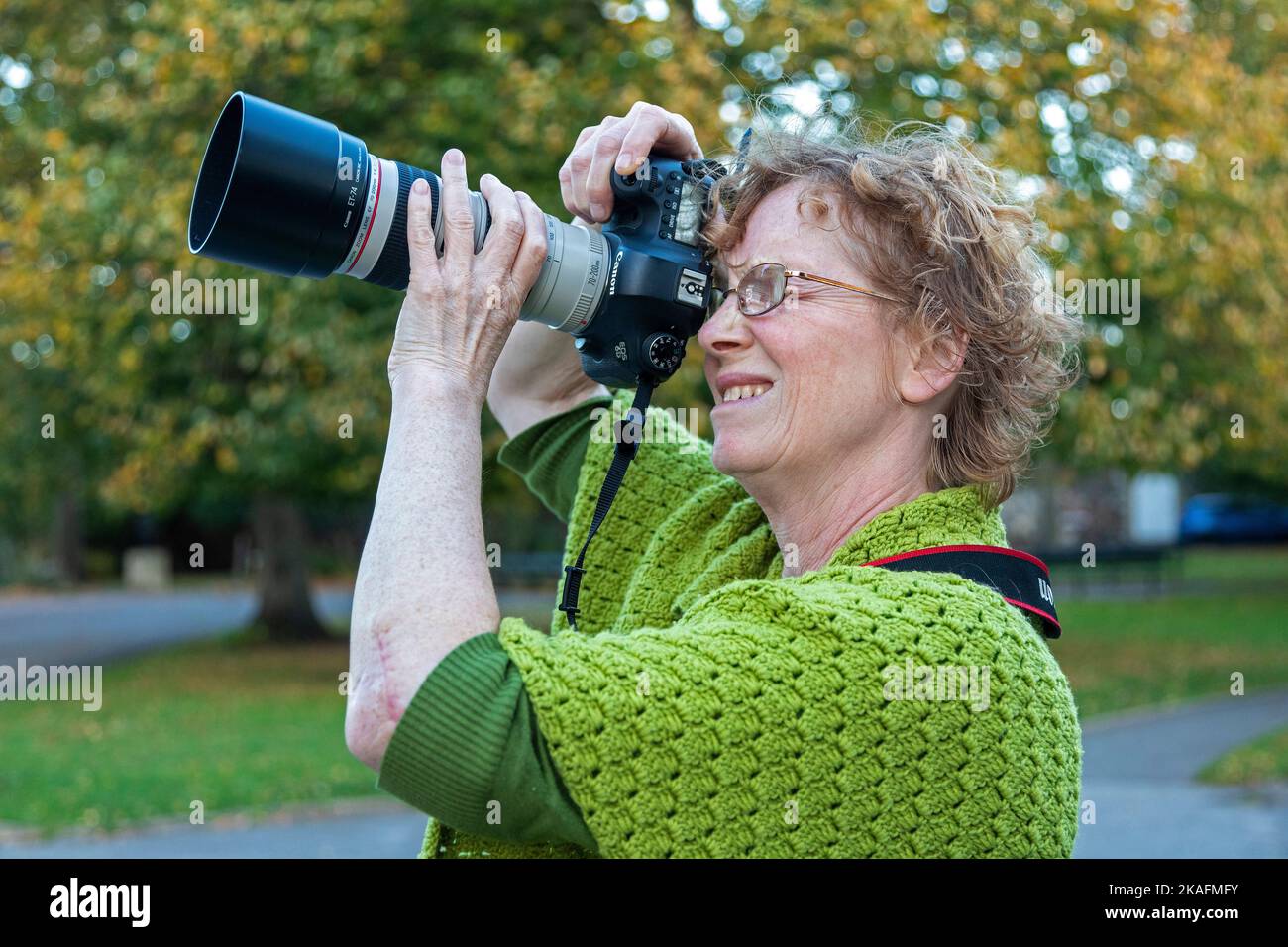 Woman taking photographs, Canterbury, Kent, England, Great Britain ...