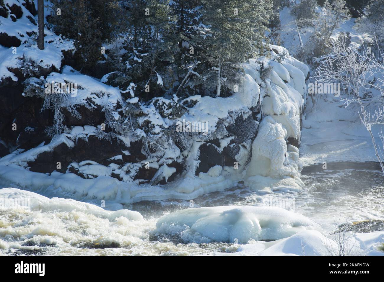 A closeup shot of a beautiful white snow covering rocks and ground near ...