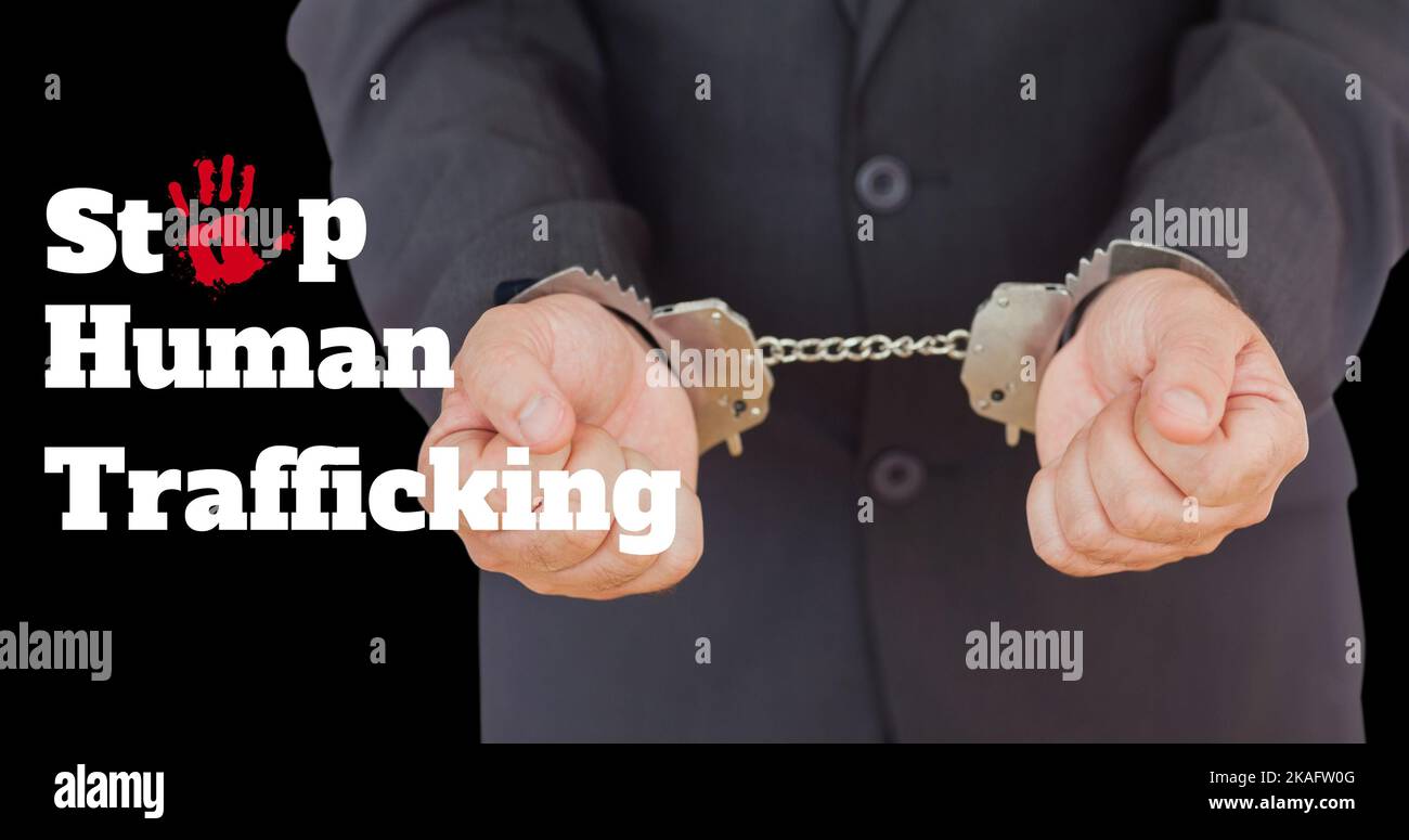 Composite of stop human trafficking text and midsection of caucasian businessman with handcuffs Stock Photo