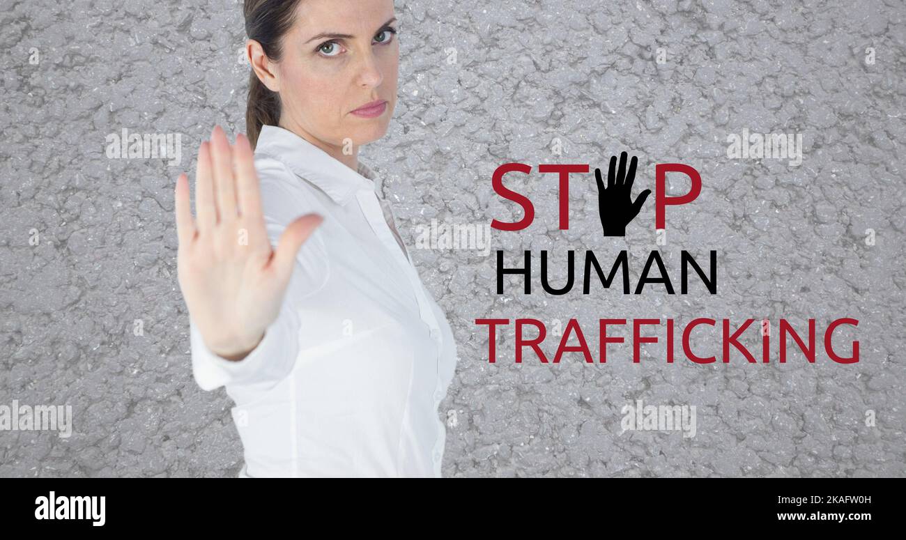 Composite of caucasian businesswoman showing stop sign and stop human trafficking text Stock Photo