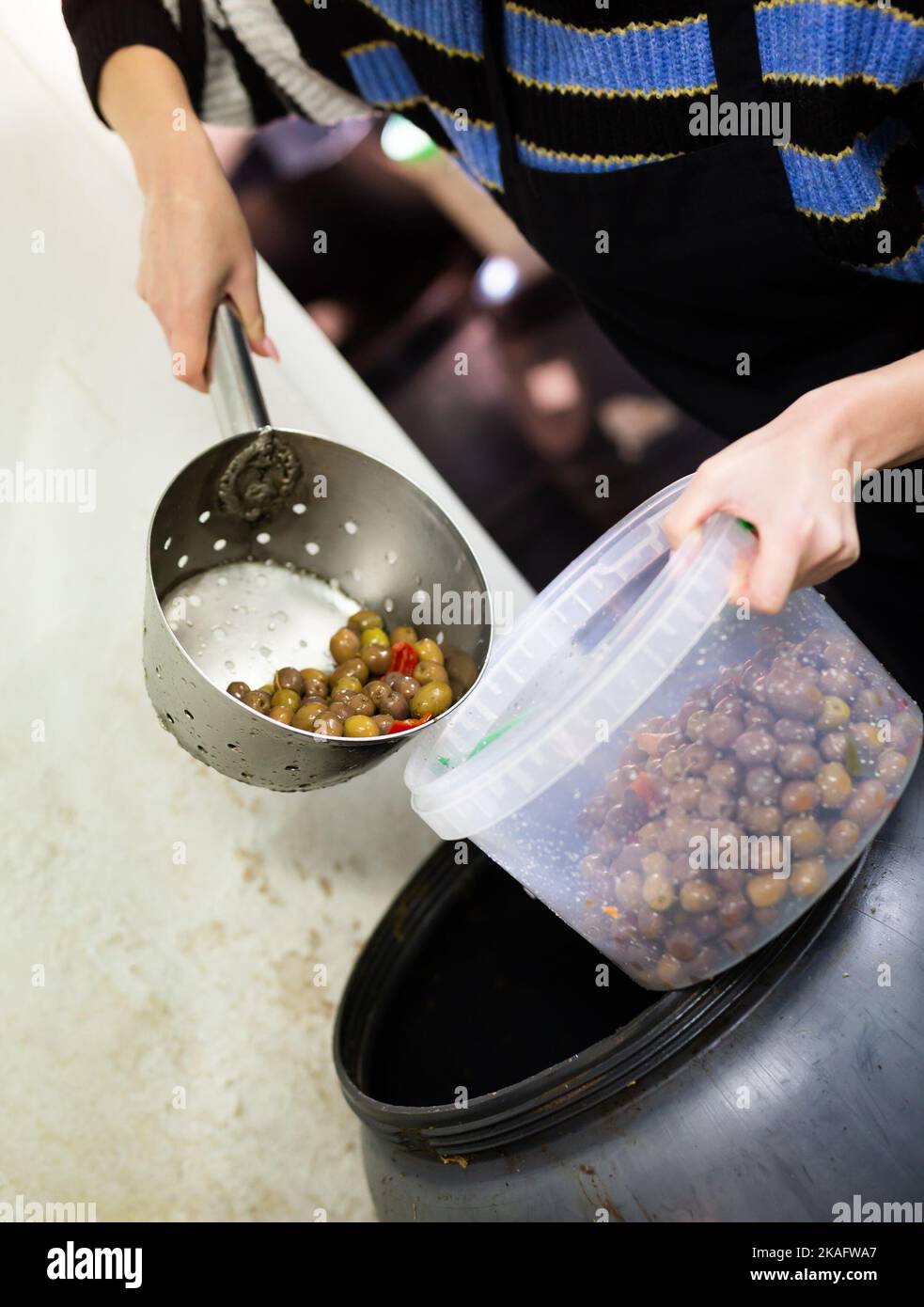 Packing olives in plastic containers Stock Photo Alamy