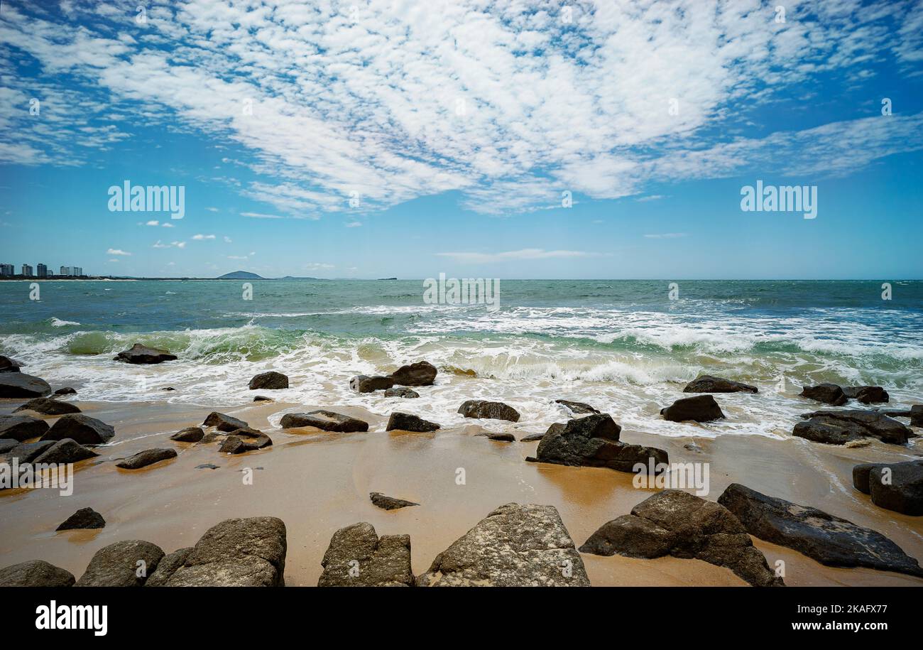 Looking north from Alexandra Headland beach, a coastal part of Maroochydore,Sunshine Coast, Queensland, Australia. Rocky foreshore with waves breaking Stock Photo