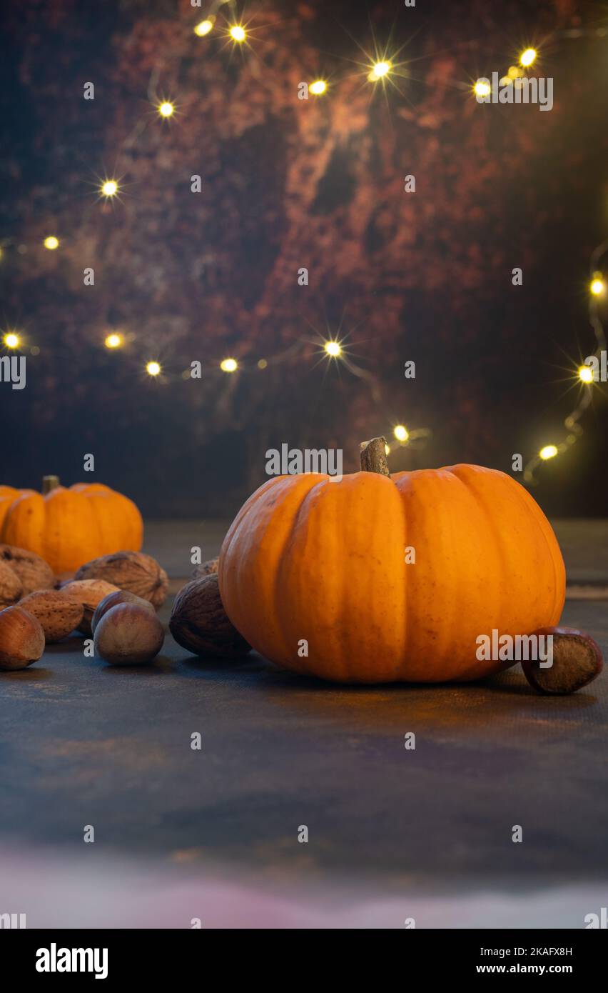 Autumn pumpkins and fall decor on a rustic background illuminated with ...