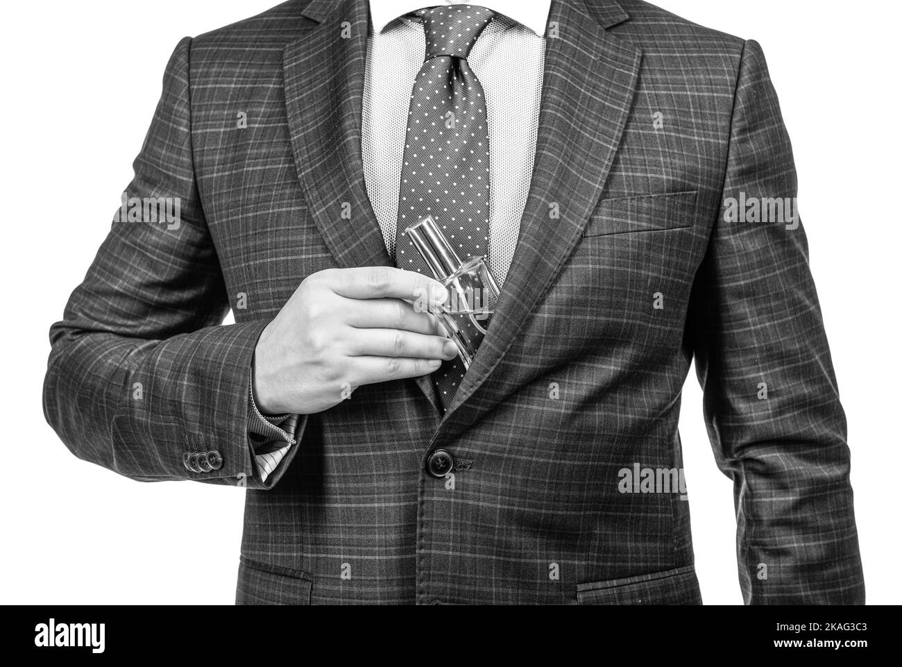 Businessman cropped view pull perfume bottle from suit jacket isolated on white, classic cologne Stock Photo