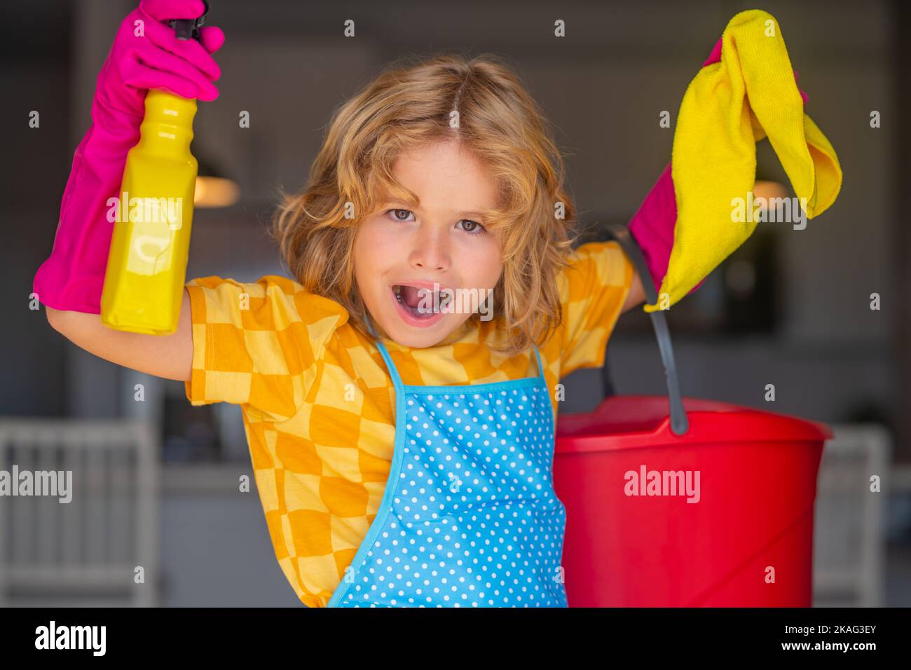 Portrait of child helping with housework, cleaning the house. Housekeeping, home chores. Stock Photo