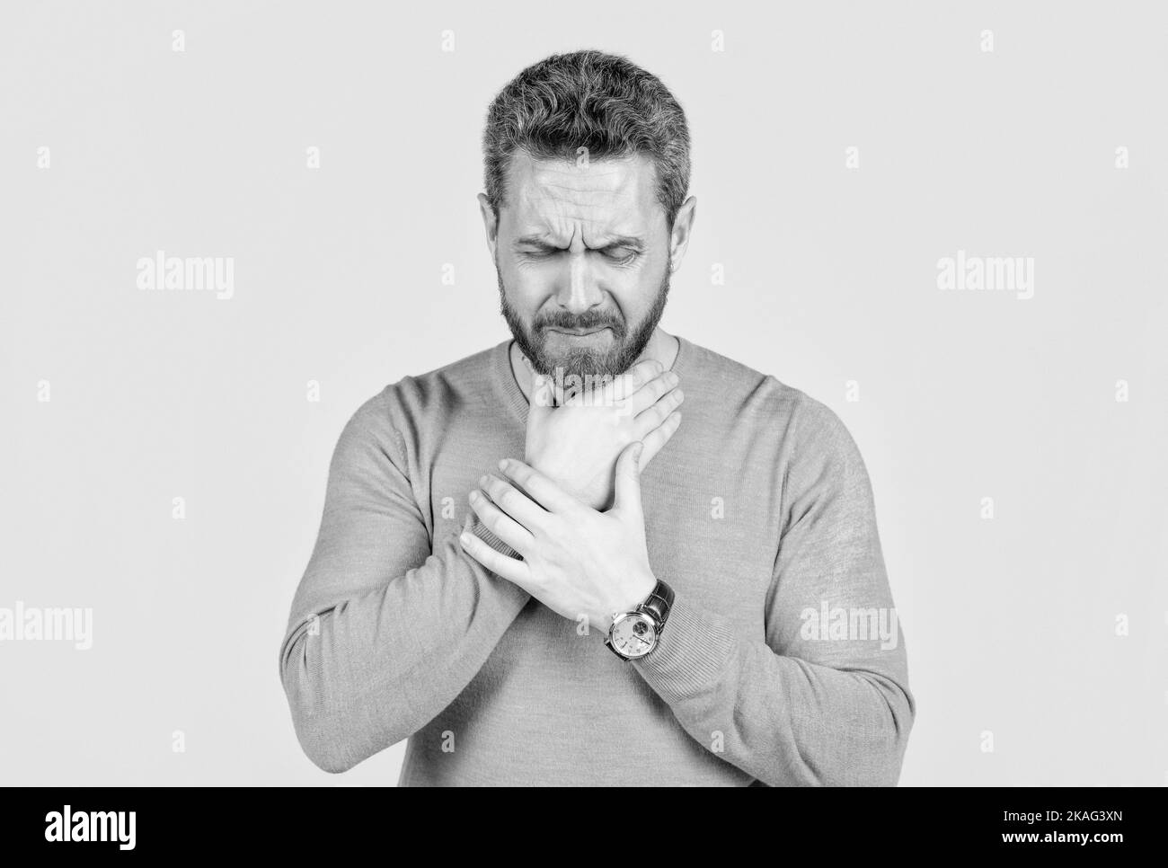 mature man with beard suffer from sore throat on grey background, cold ...
