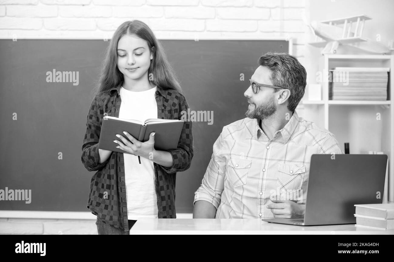 dad and daughter use notebook. back to school. childhood education