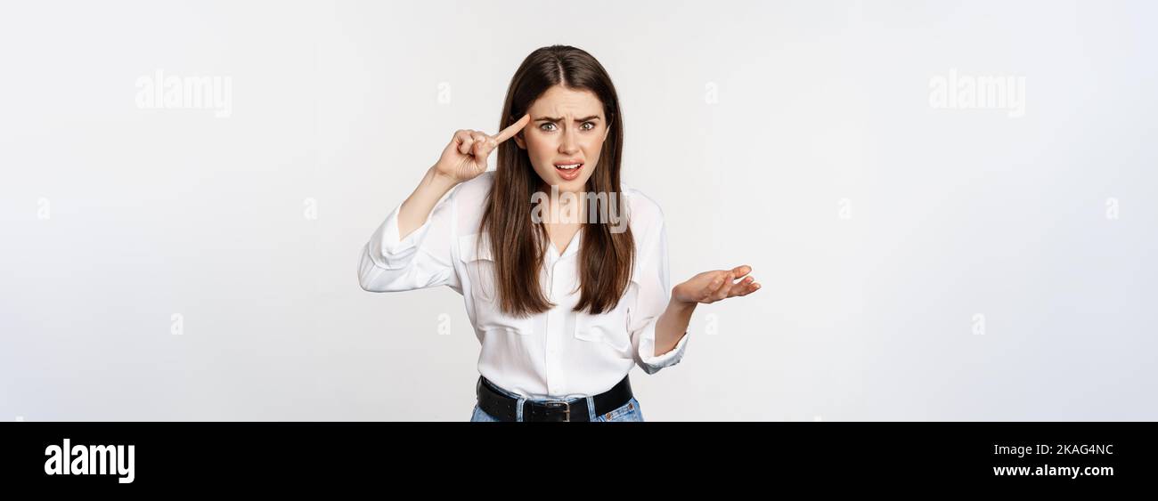 Someone Bothered Are you dumb. Annoyed woman scolding, roll finger over head and staring ...