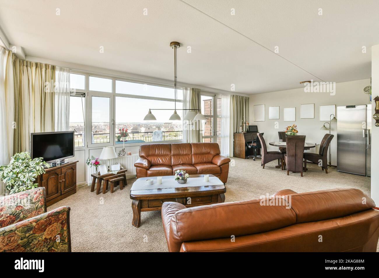 Piano and carpet placed in light living room with panoramic windows