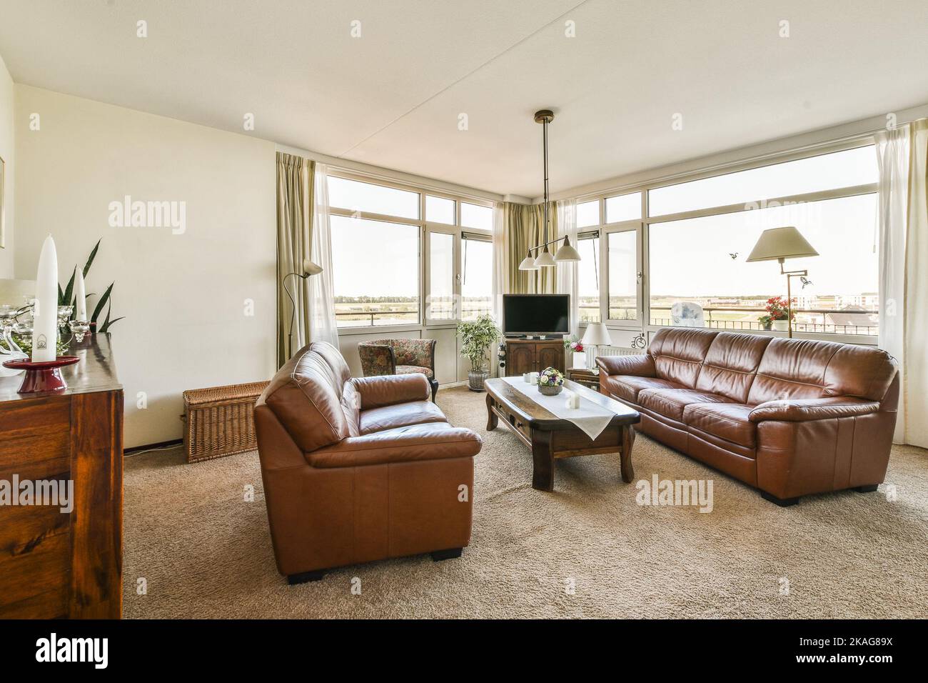 Piano and carpet placed in light living room with panoramic windows