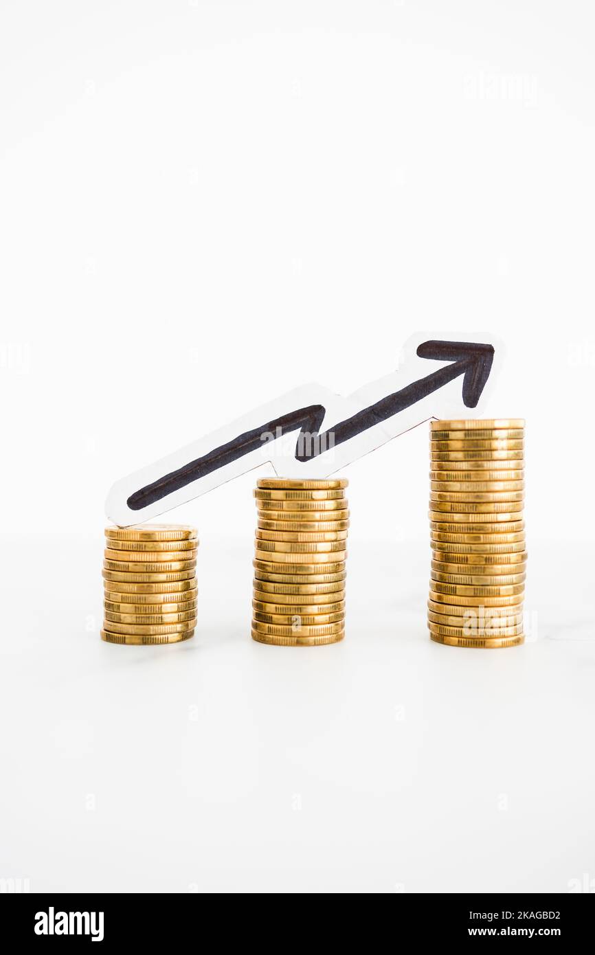growing stacks of coins with arrow pointing upward, metaphor of