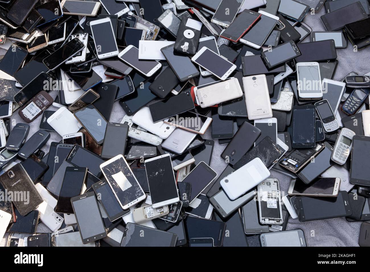 Prague, CZ - 05 September 2022:  A heap of Used mobile, Various brand Old smartphones gadgets with private media. Many types and generations of  mobil Stock Photo