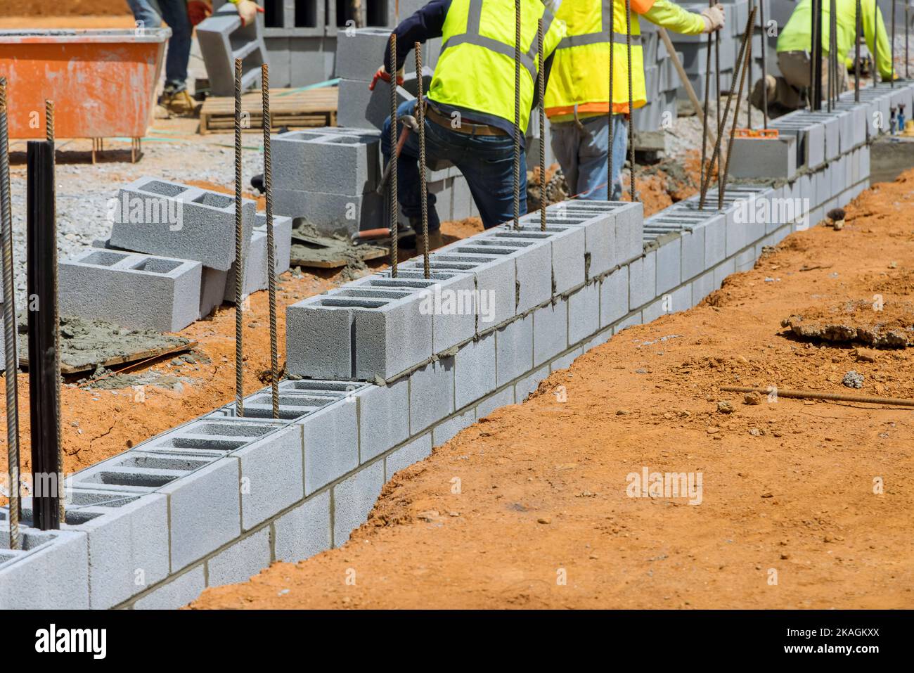 An employee mason bricklayer company laying down mounting of wall