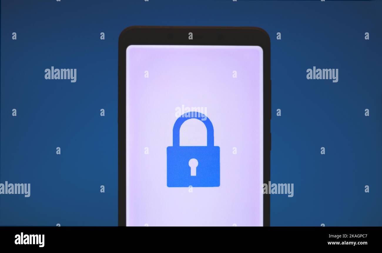 Blue padlock or lock icon on mobile screen. Blue background Stock Photo