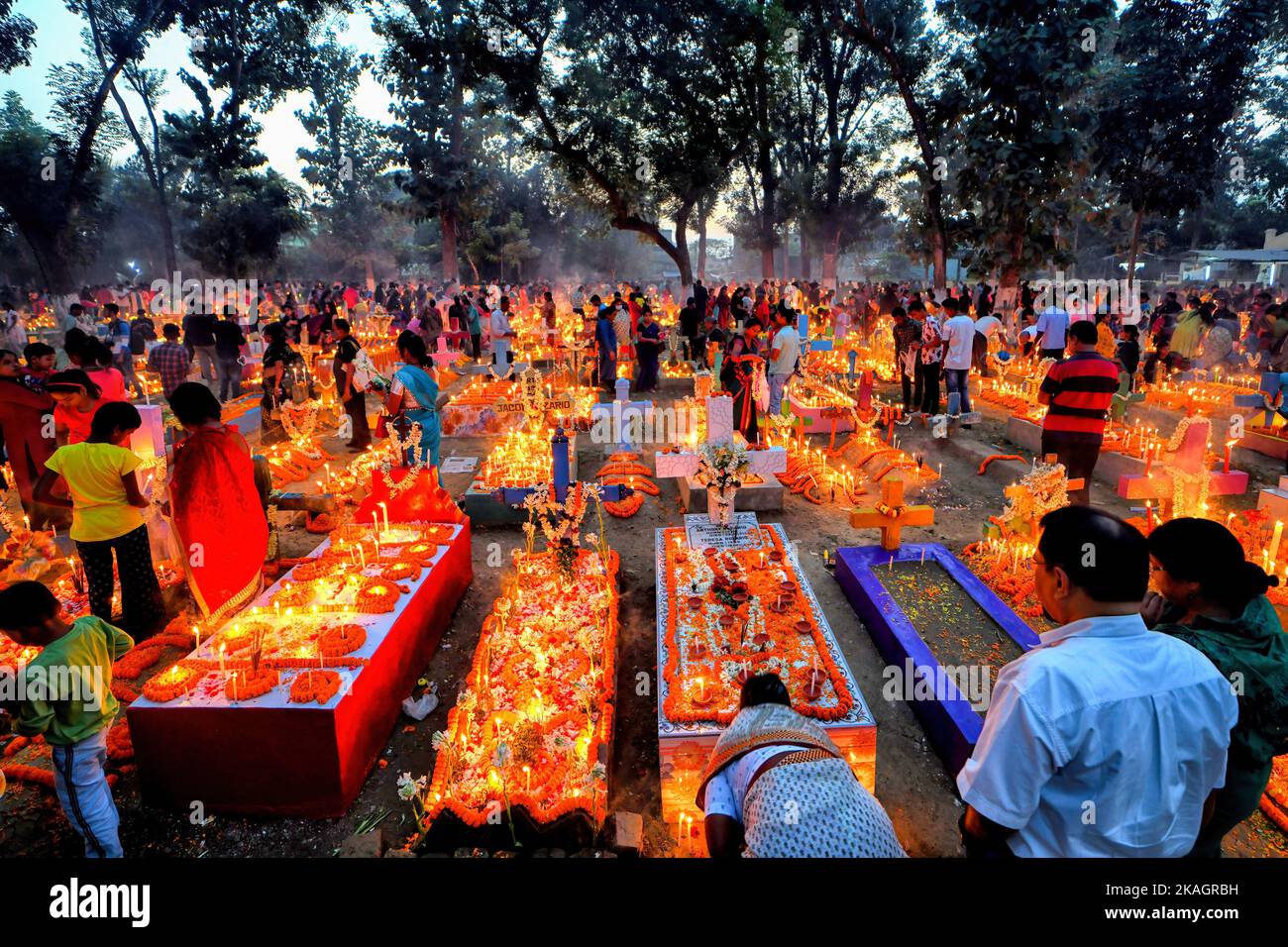Christian family members pay respect and offer prayers beside the ...