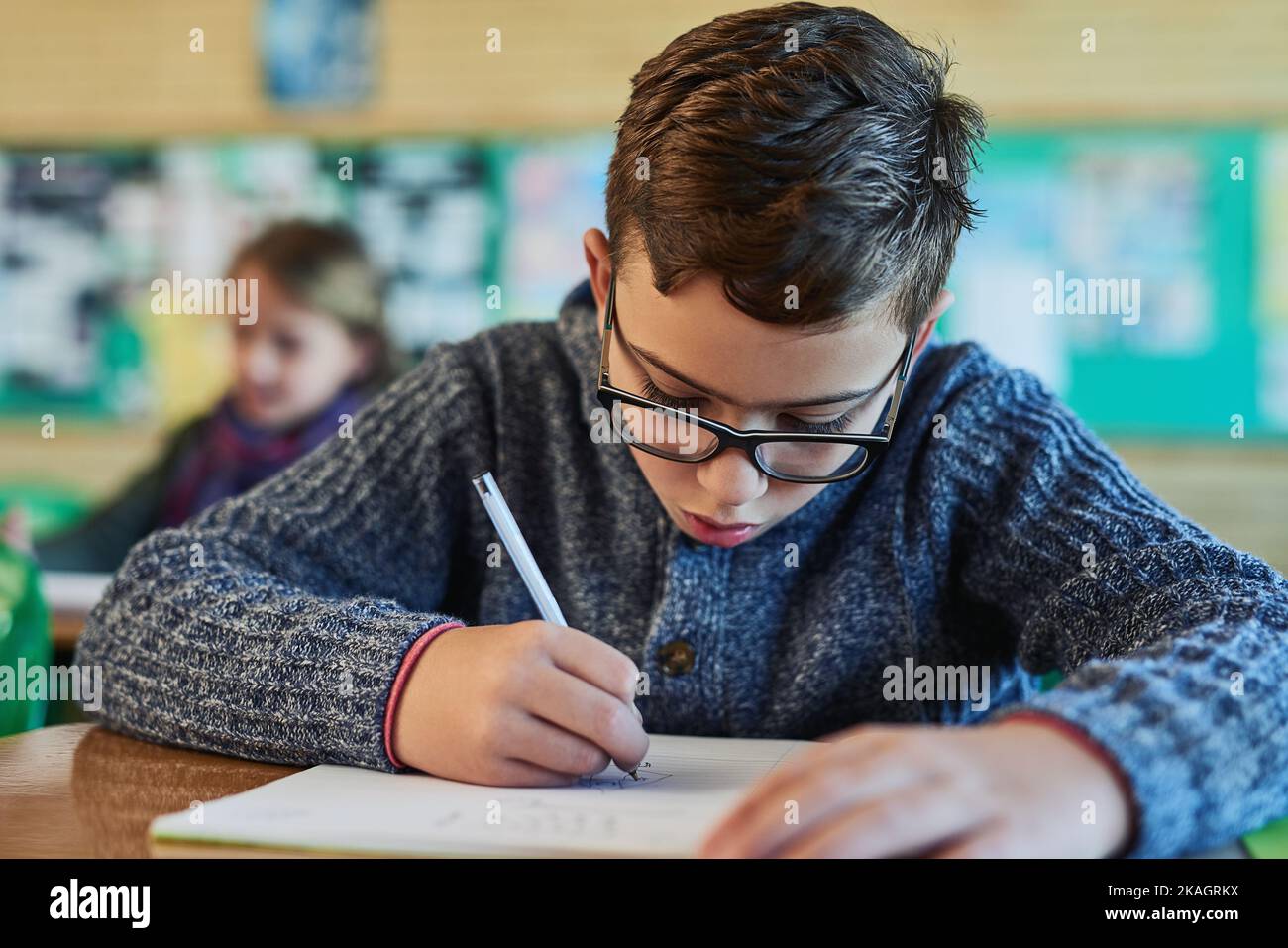 Got to work hard to stay a top student. an elementary school boy working in class. Stock Photo
