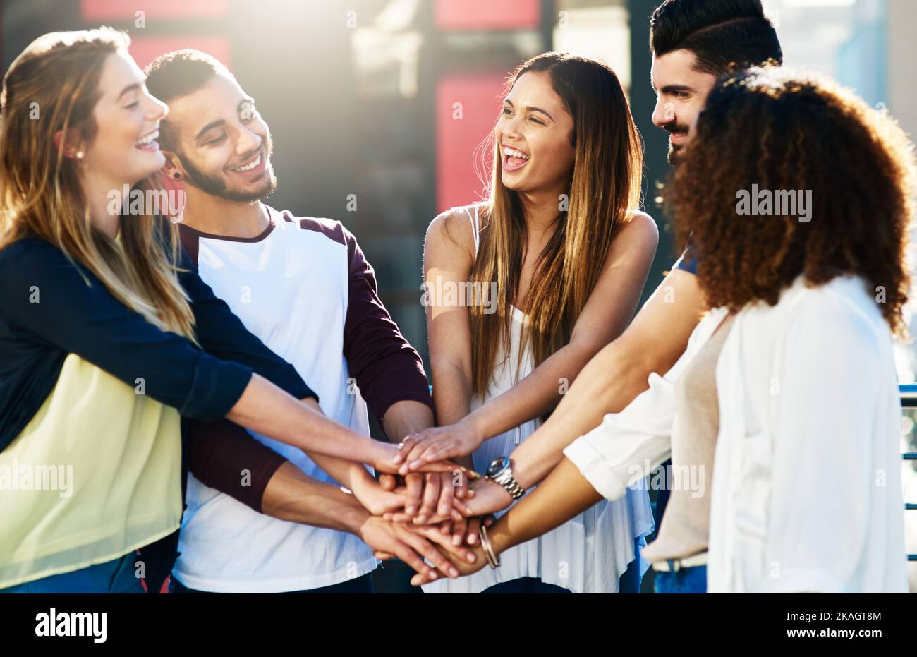 Grouped together to support. a group of young people putting their