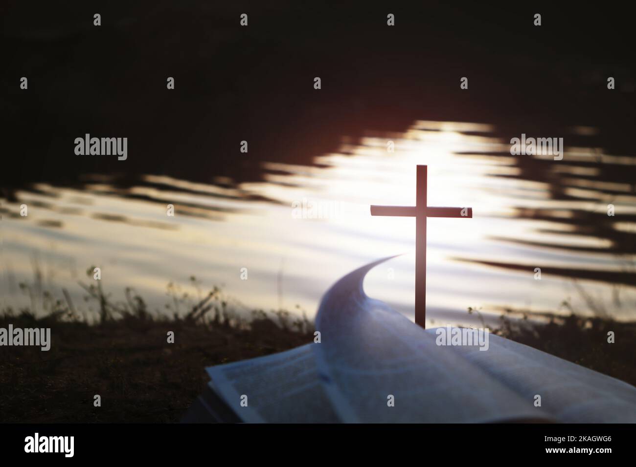 The holy bible and the cross of Jesus Christ on the shore of the sunset