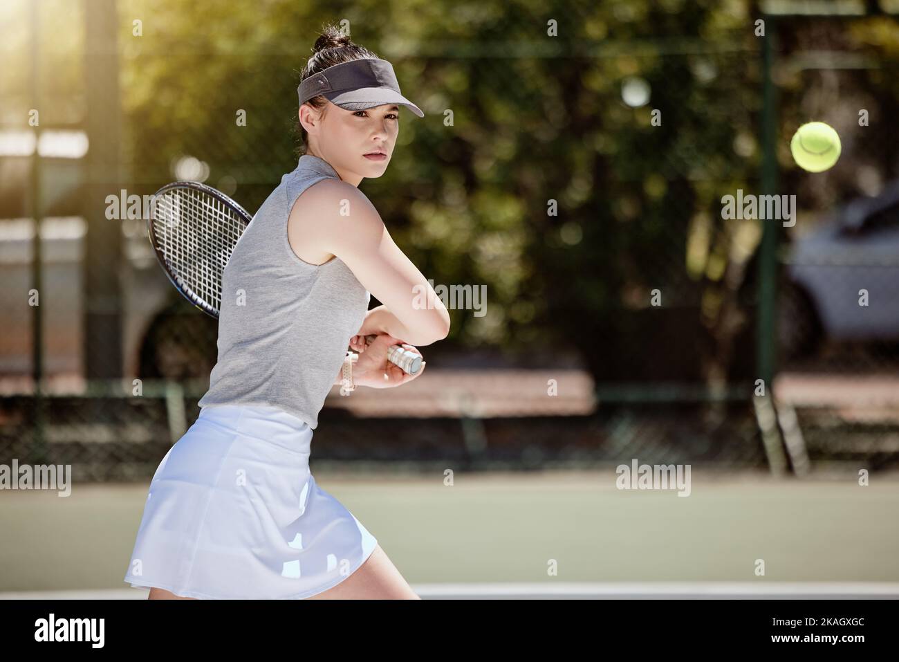 Fitness, sports and tennis with woman on court training for game, strike and playing competition match. Workout, exercise and health with girl tennis Stock Photo