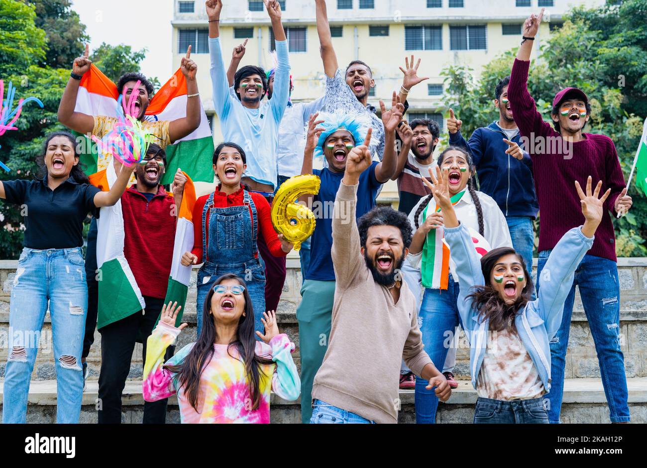 excited audience celebrating sixer by shouting and screaming by showing hand gestures and signs while watching cricket match at stadium - concept of Stock Photo