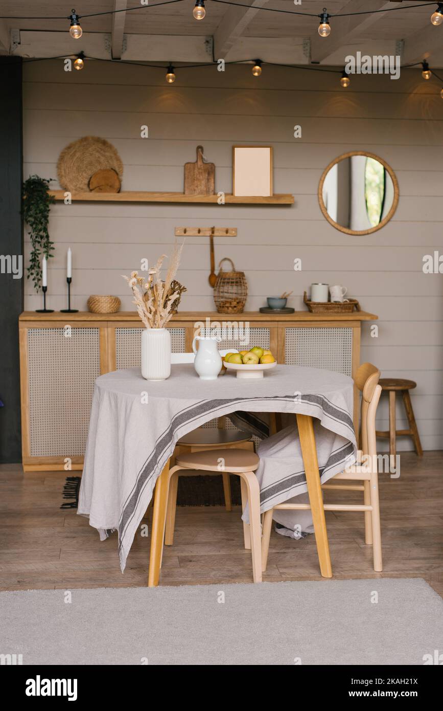 Image showcasing Wooden kitchen in a country house with a round dining table in ...