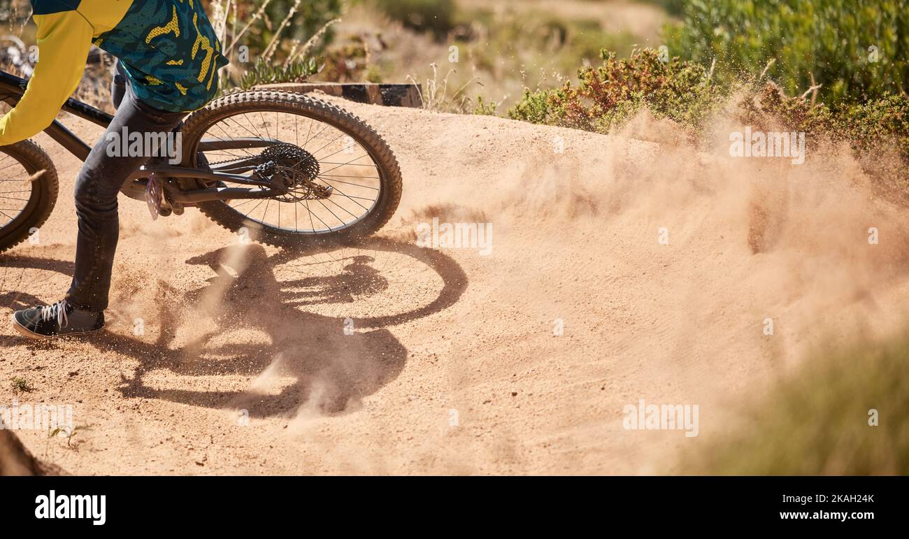 Extreme sport, dirt bike and dust with cyclist riding for adrenaline in competitive competition. Bicycle, fast and biking mountain bike racer ride on Stock Photo