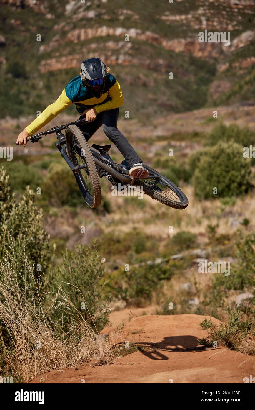 Jump, mountain bike and cyclist performing extreme sport stunt on his bike.  Adrenaline, fitness and biking man riding while jumping for competitive  Stock Photo - Alamy