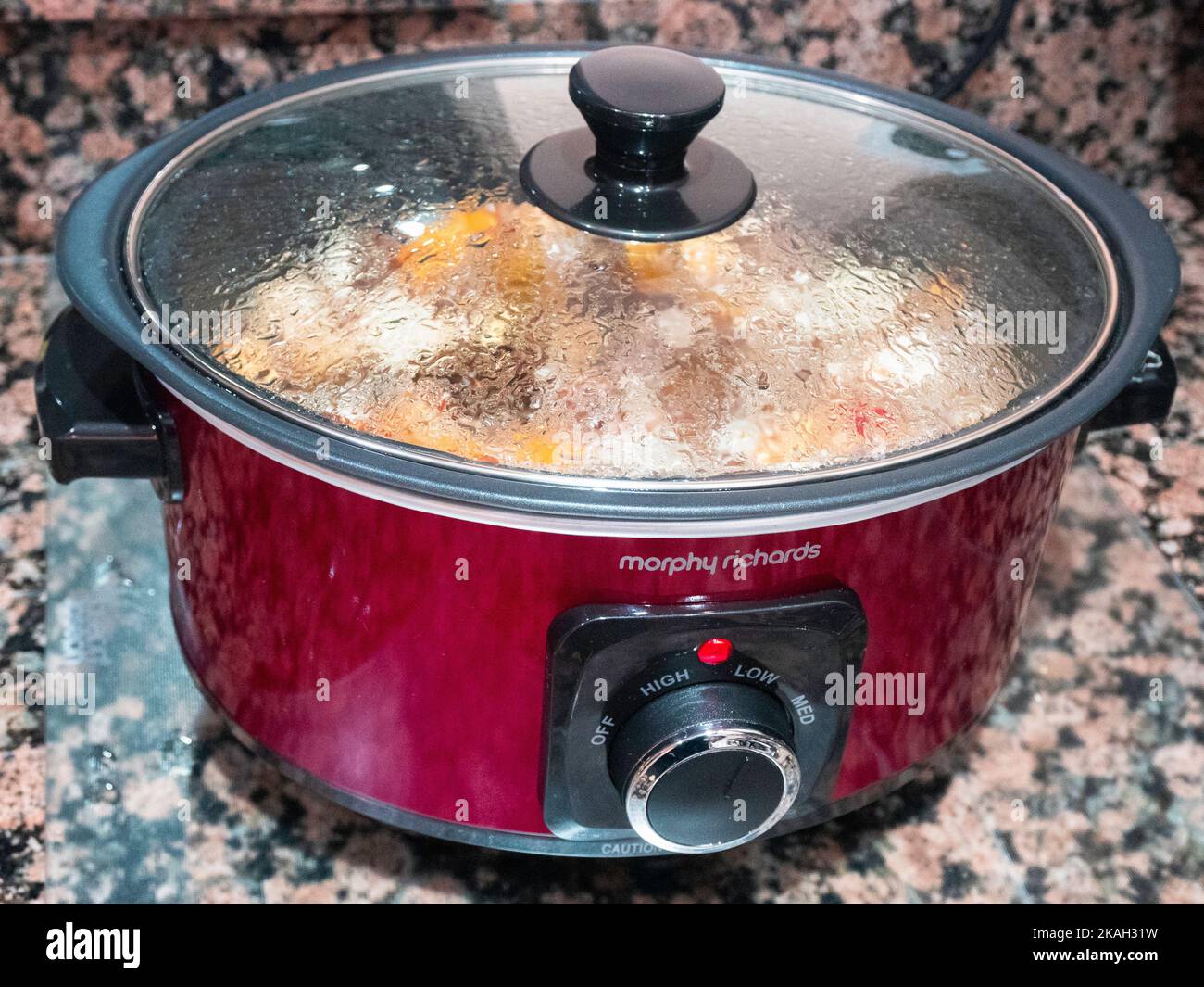 A Morphy Richards  slow cooker kitchen electrical appliance which cooks a prepared stew overnight delivering tasty food with low energy consumption Stock Photo