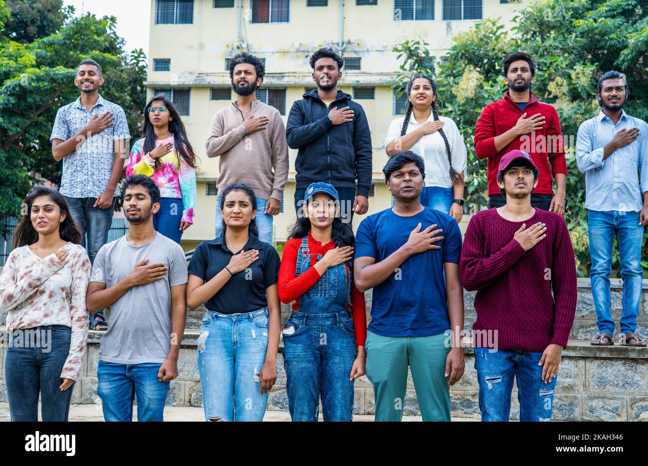 audience praying for singing national anthem stadium before match - concept of championship, patriotism and togetherness. Stock Photo