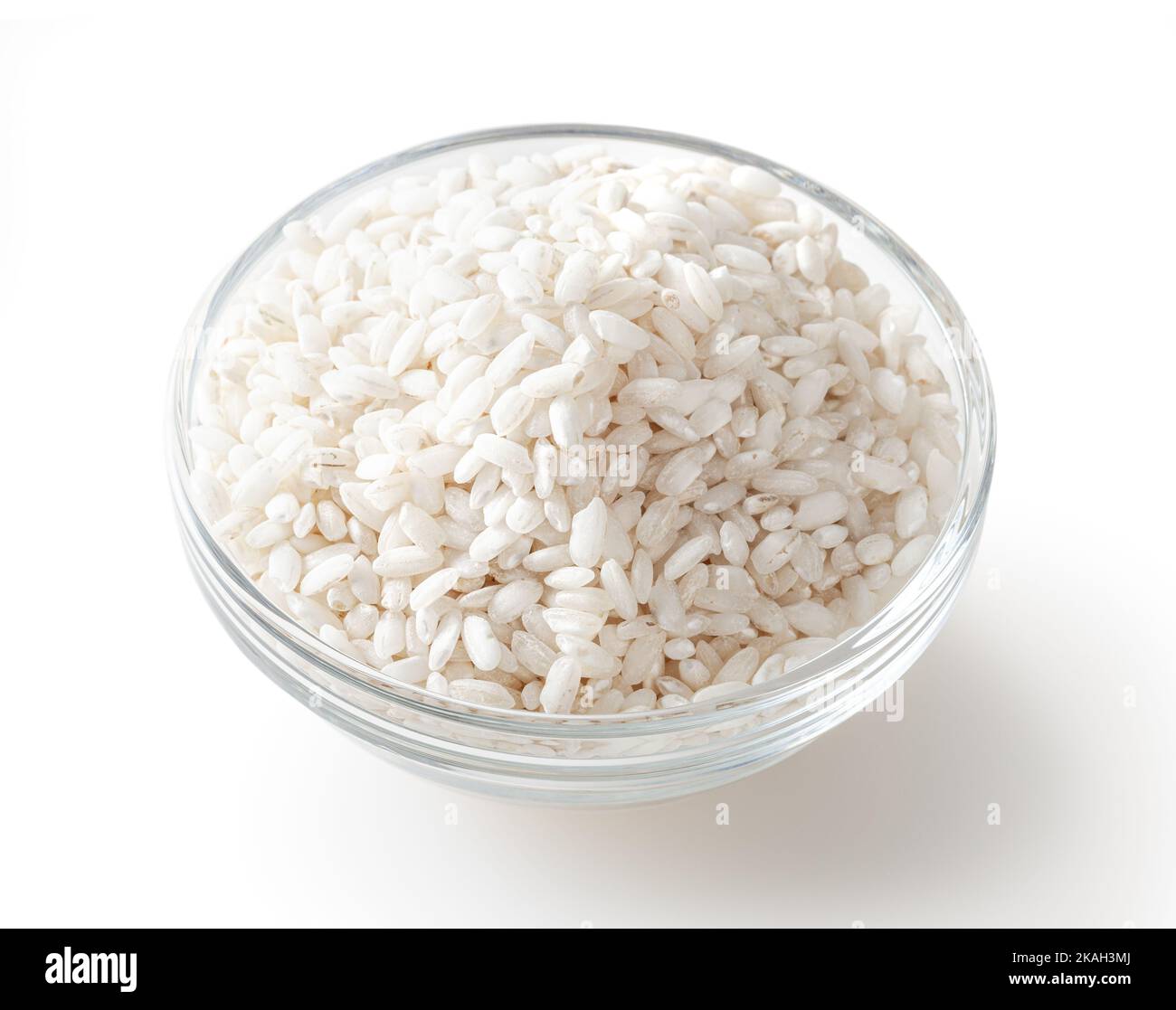 Uncooked arborio rice in glass bowl isolated on white background with