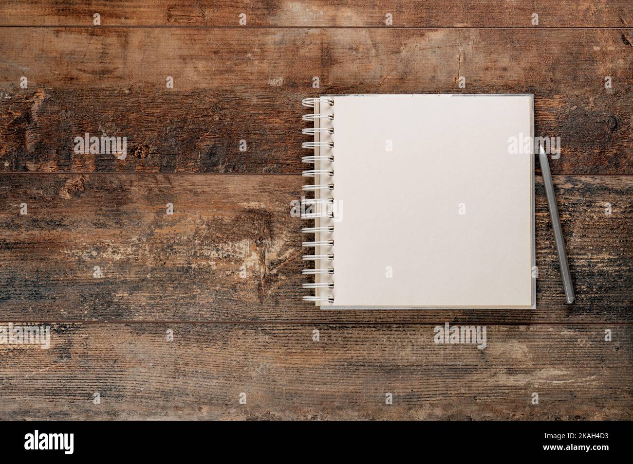 Mockup blank notebook and pen on old rustic wooden table. Mockup blank notebook and pen on old rustic wooden table Stock Photo