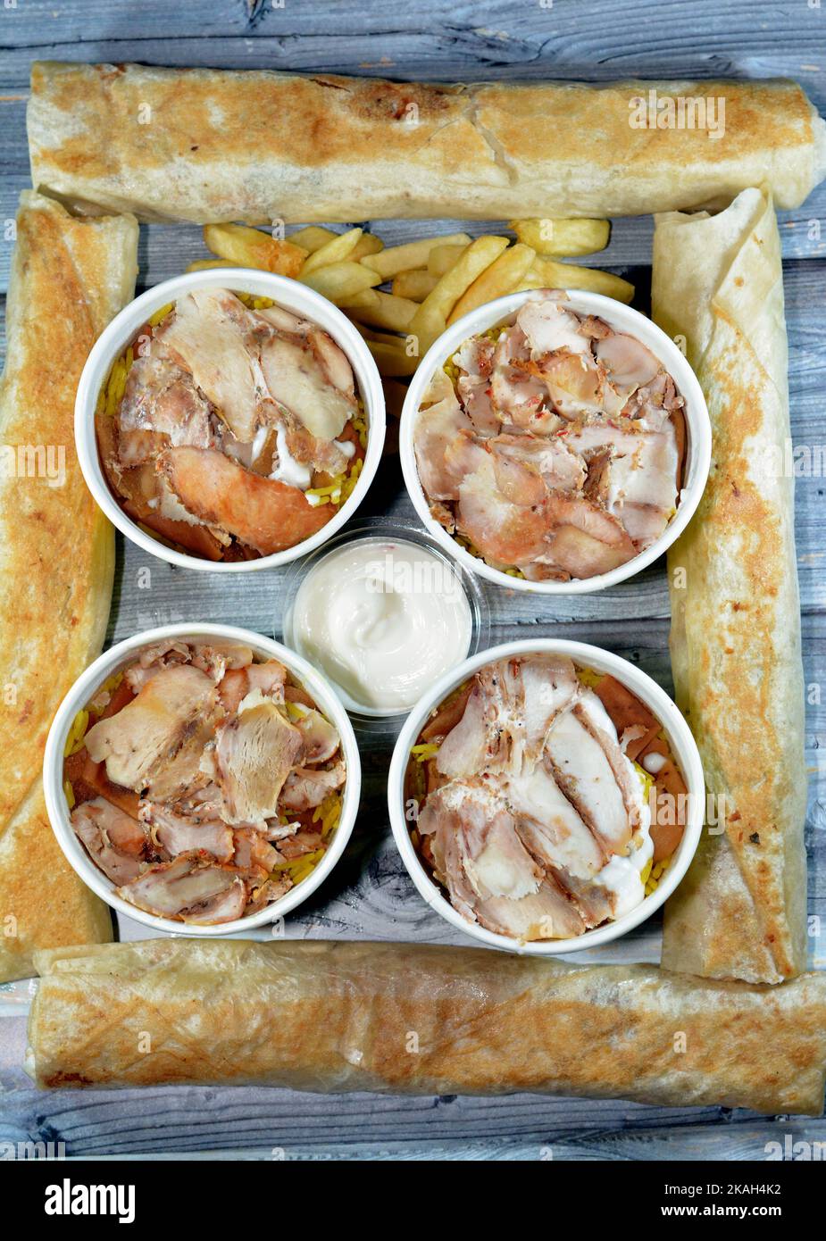 Pieces of Chicken shawarma and yellow Basmati rice, Syrian bread and