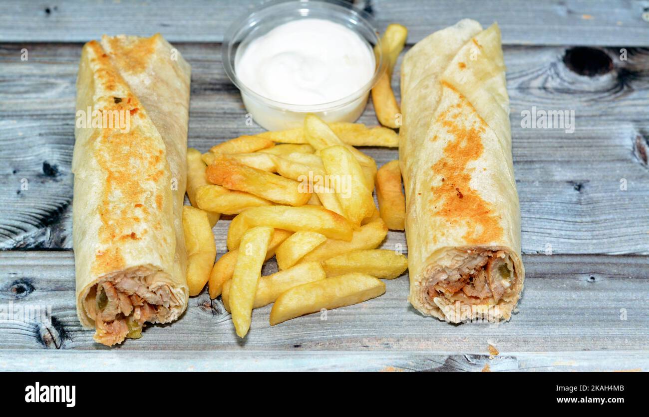 Syrian recipe cuisine background, chicken shawerma or shawarma tortilla