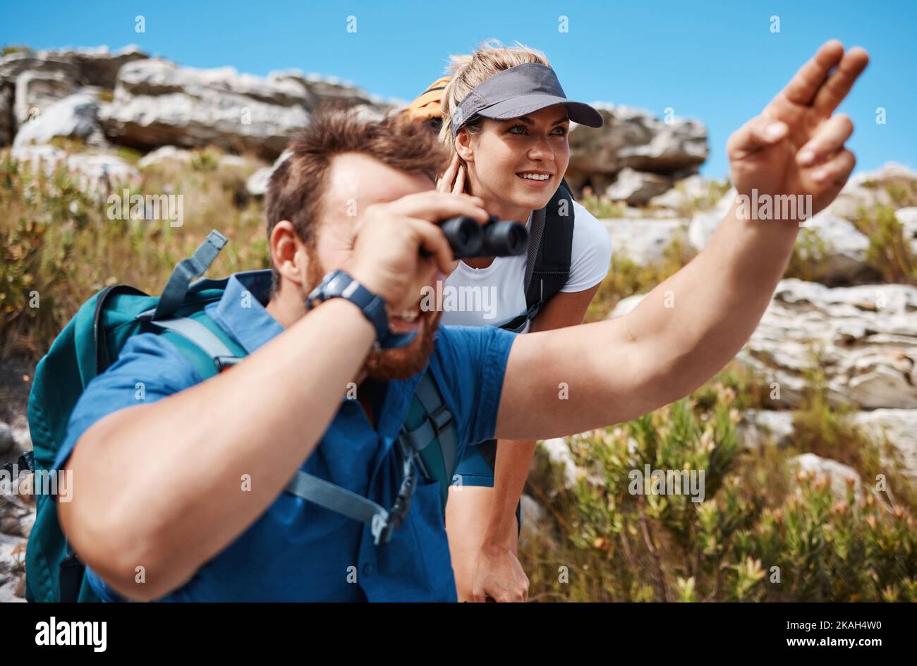 Couple, binocular and hiking in mountain and enjoy view, exercise and