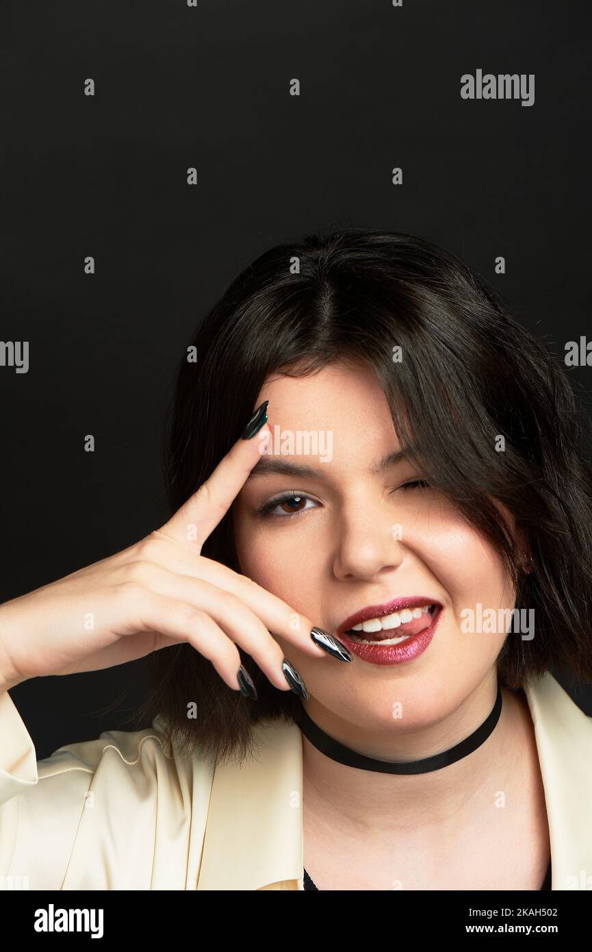 A brash girl with a dark scarf. With dark long nails. Teenage rebellion