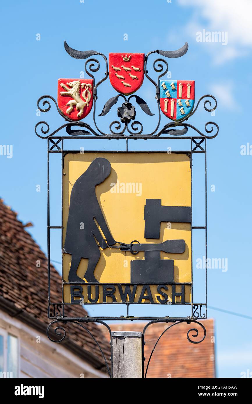Burwash village sign illustrating the Wealden Iron industry, Burwash, East Sussex, England, UK Stock Photo