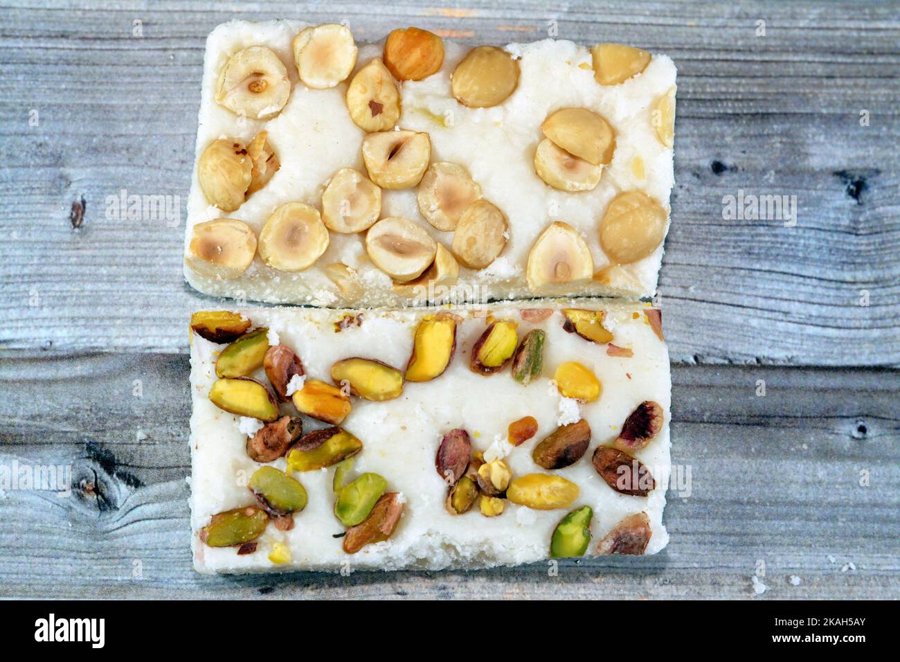 Arabian sweet candies of soft coconuts covered with pistachios and ...
