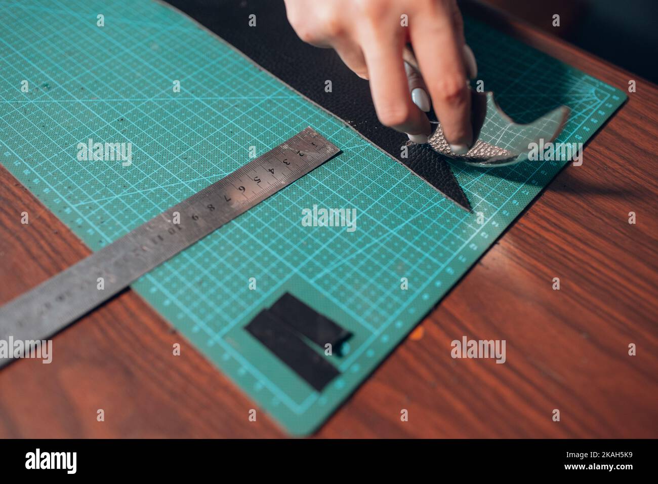 Tanner woman cutting leather goods on Working process of