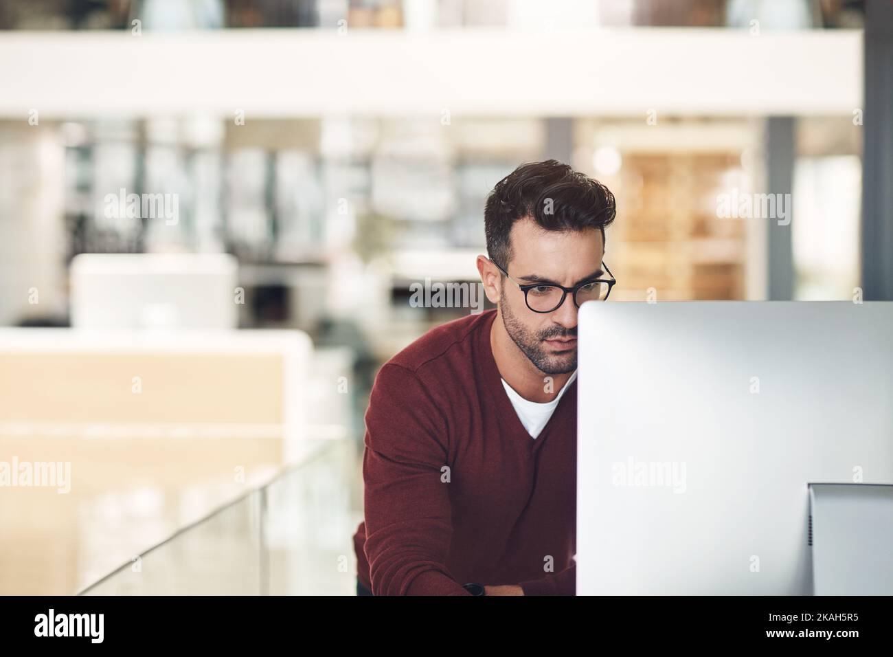He analyses his work thoroughly. a young businessman in the office. Stock Photo