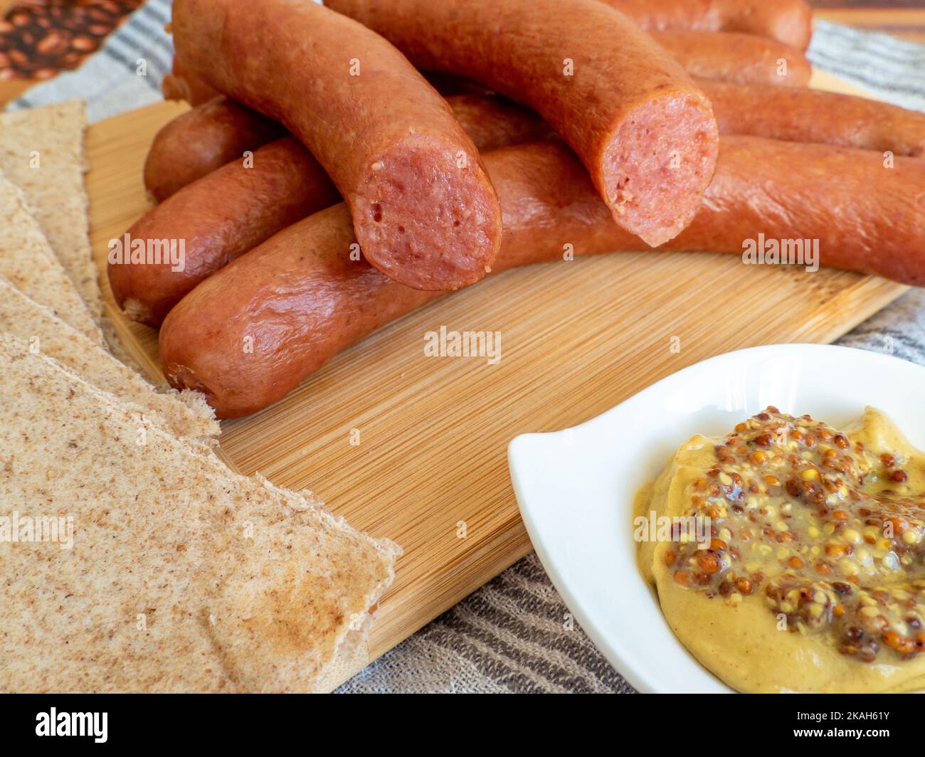 virstli, transylvanian sausages on a wooden board with mustard Stock Photo