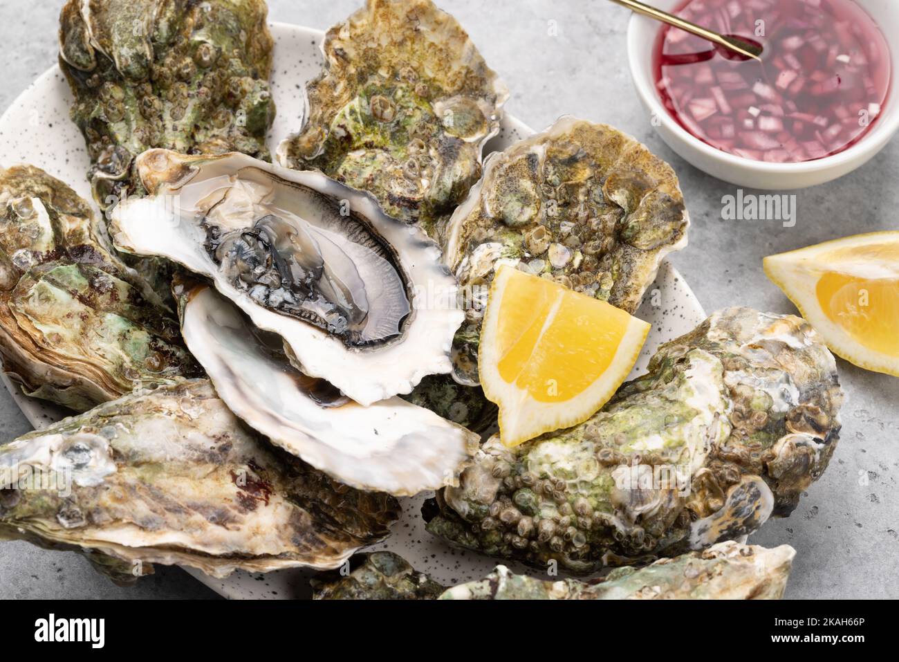 Fresh oysters with lemons and sauce. Closeup Stock Photo Alamy