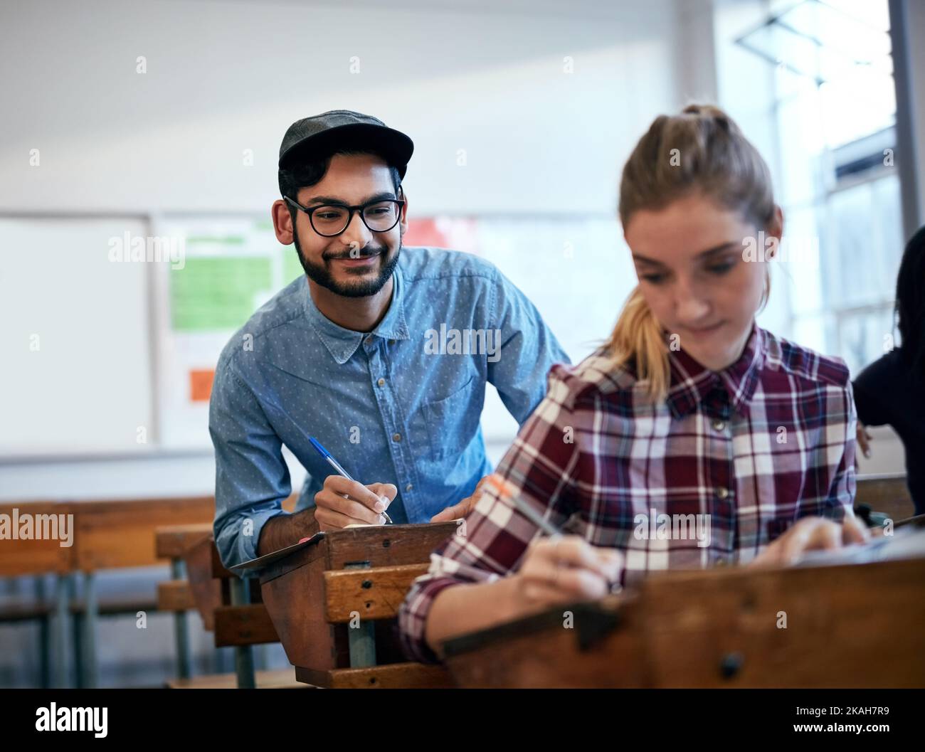 Cheating is never okay. an university student trying to cheat in class. Stock Photo
