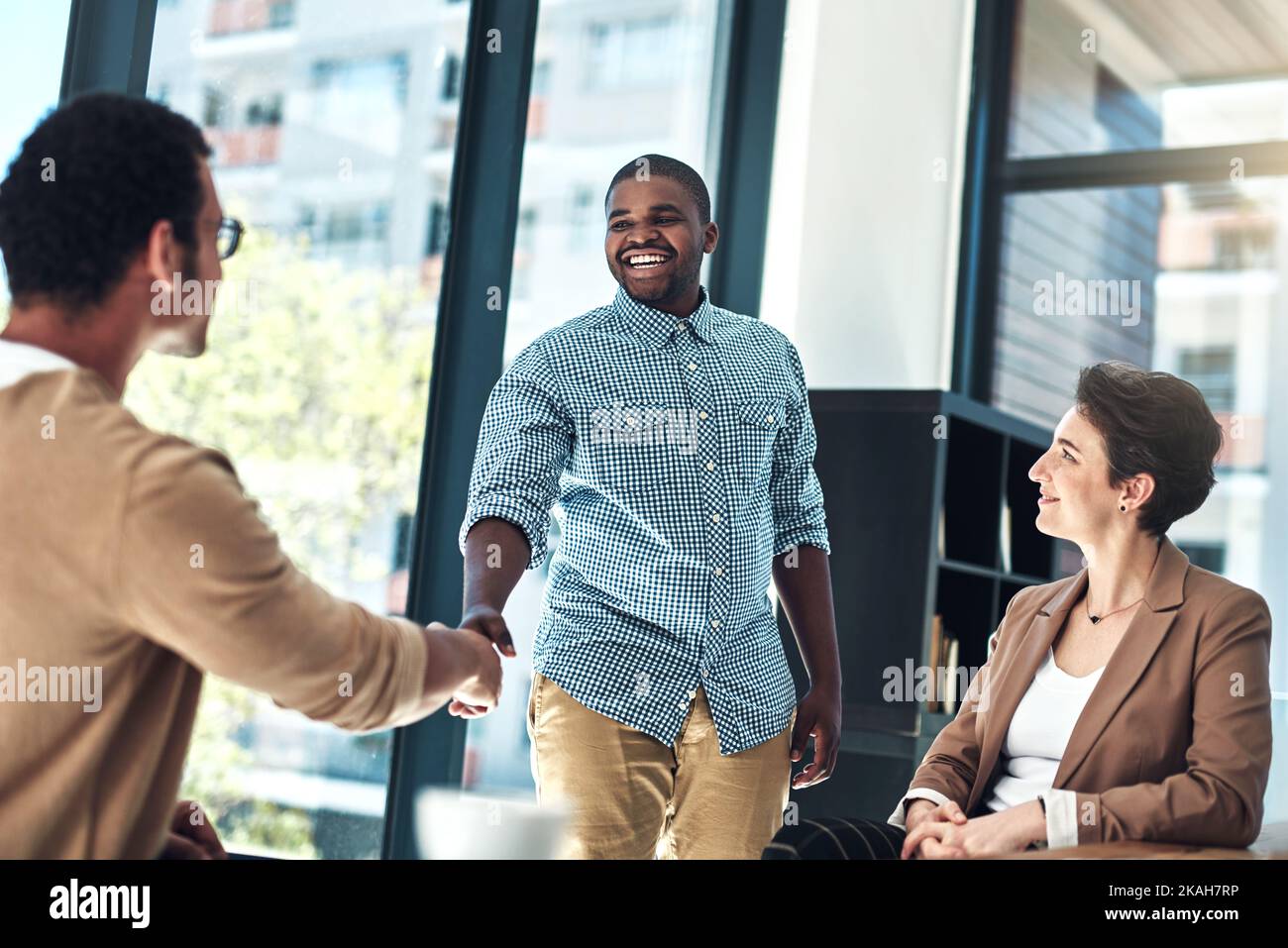 I cant wait to share my creative ideas with you. designer shaking hands in the office. Stock Photo