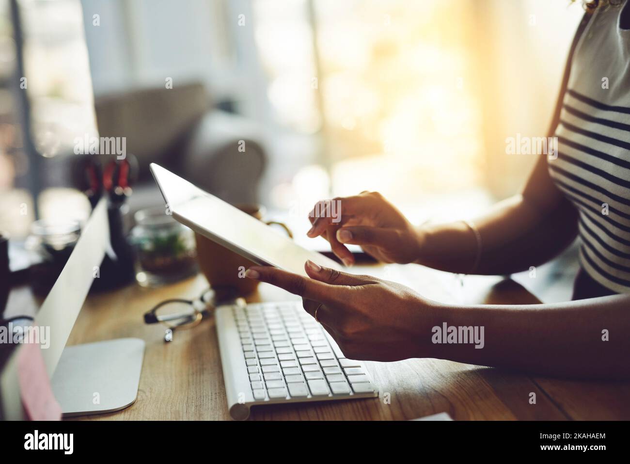 Working wirelessly. an unrecognizable businesswoman working on a digital tablet. Stock Photo
