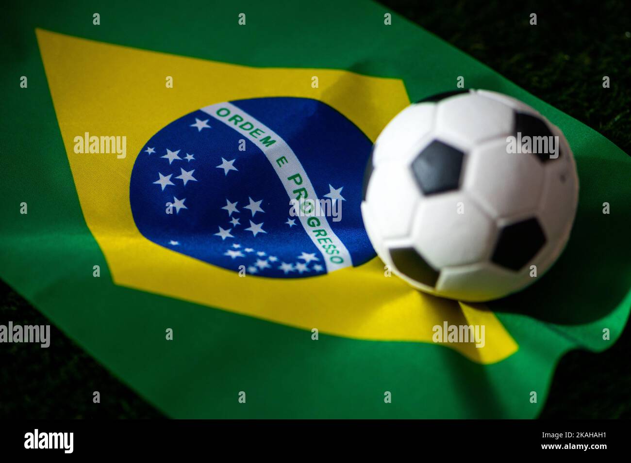 Brazil national football team. National Flag on green grass and soccer ball. Football wallpaper for Championship and Tournament in 2022. World interna Stock Photo