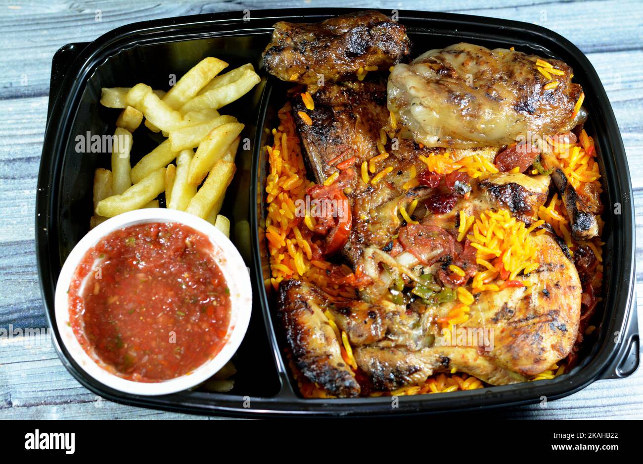 Barbecued chicken with long basmati rice and french fries, beef meat barbecued oriental tarb Kofta served with tomato dakos sauce, selective focus of Stock Photo