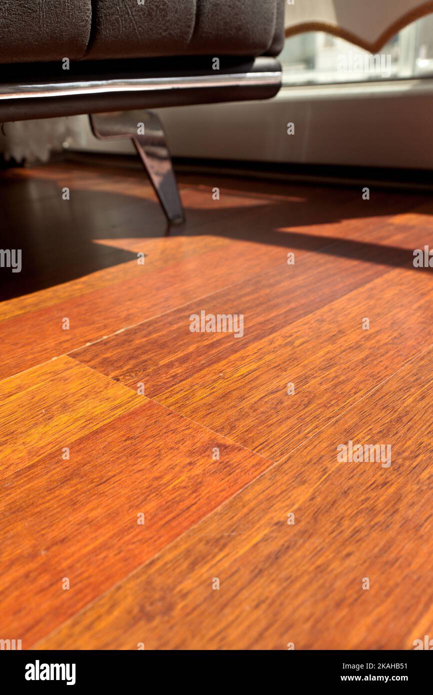 Mahogany flooring parquets in the room with armchairs in a standard home environment, mahogany wood grain texture Stock Photo