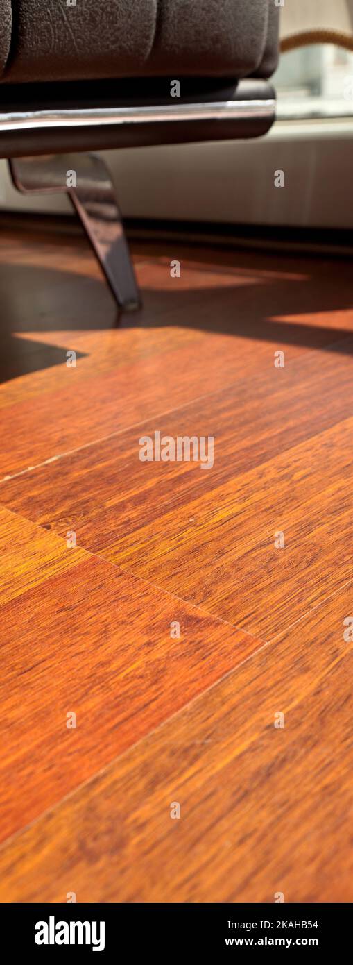 Mahogany flooring parquets in the room with armchairs in a standard home environment, mahogany wood grain texture Stock Photo